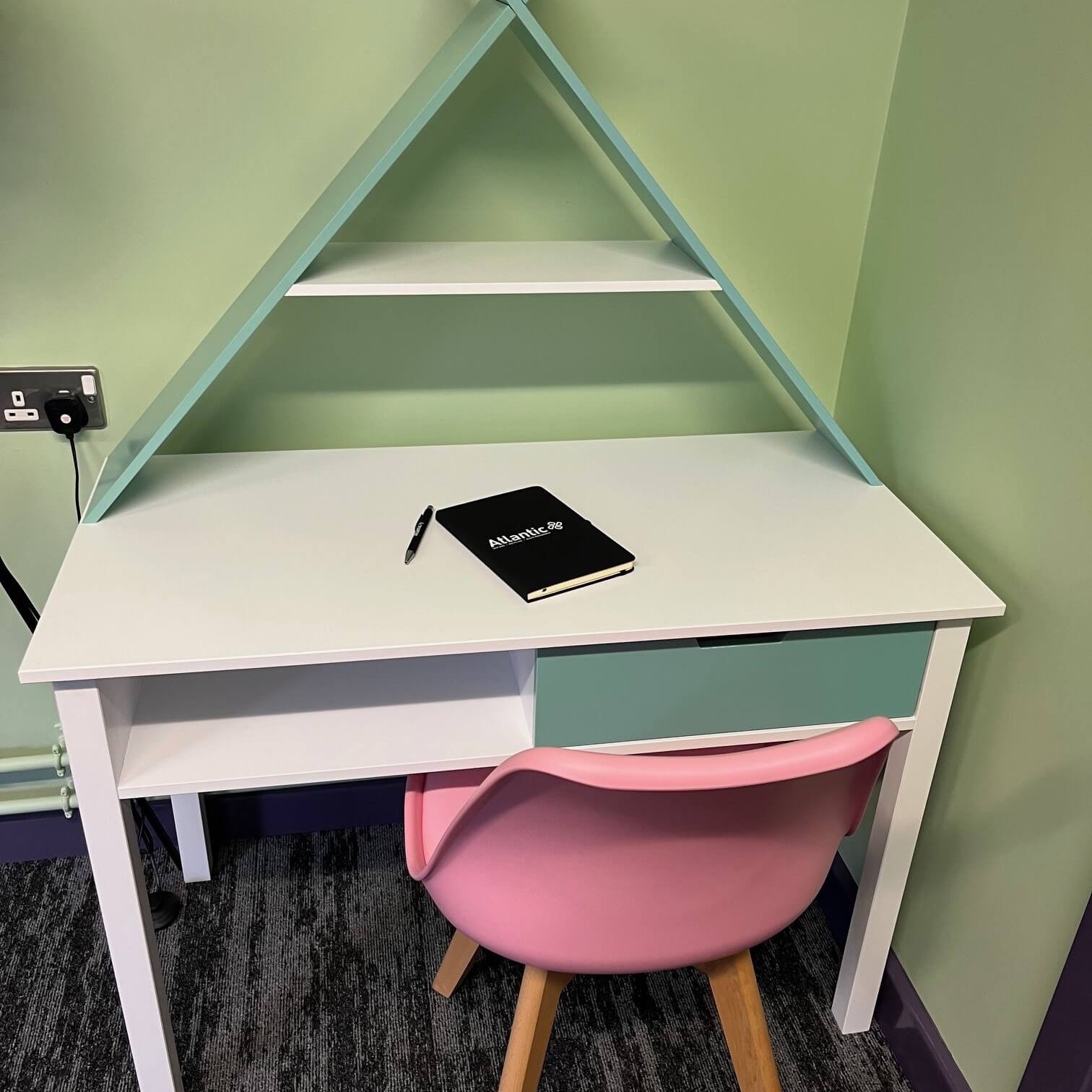 Desk with Atlantic notebook & pen on