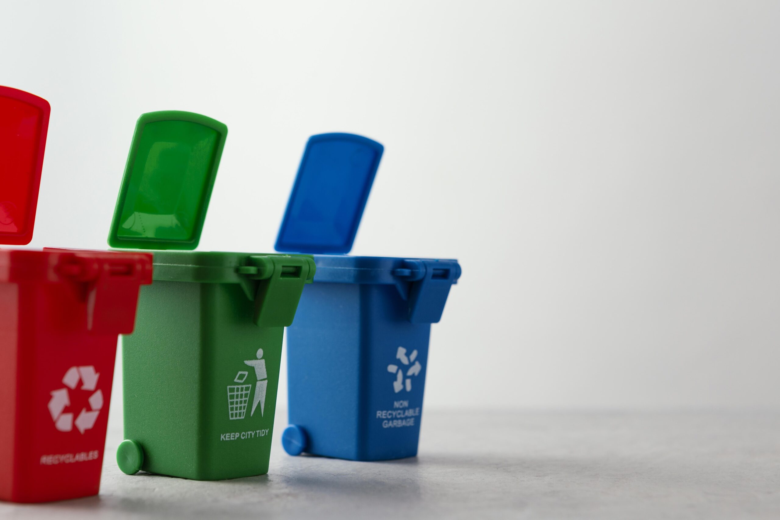 Colour-coded recycling bins promoting eco-friendly waste management and sustainable recycling practices for businesses.